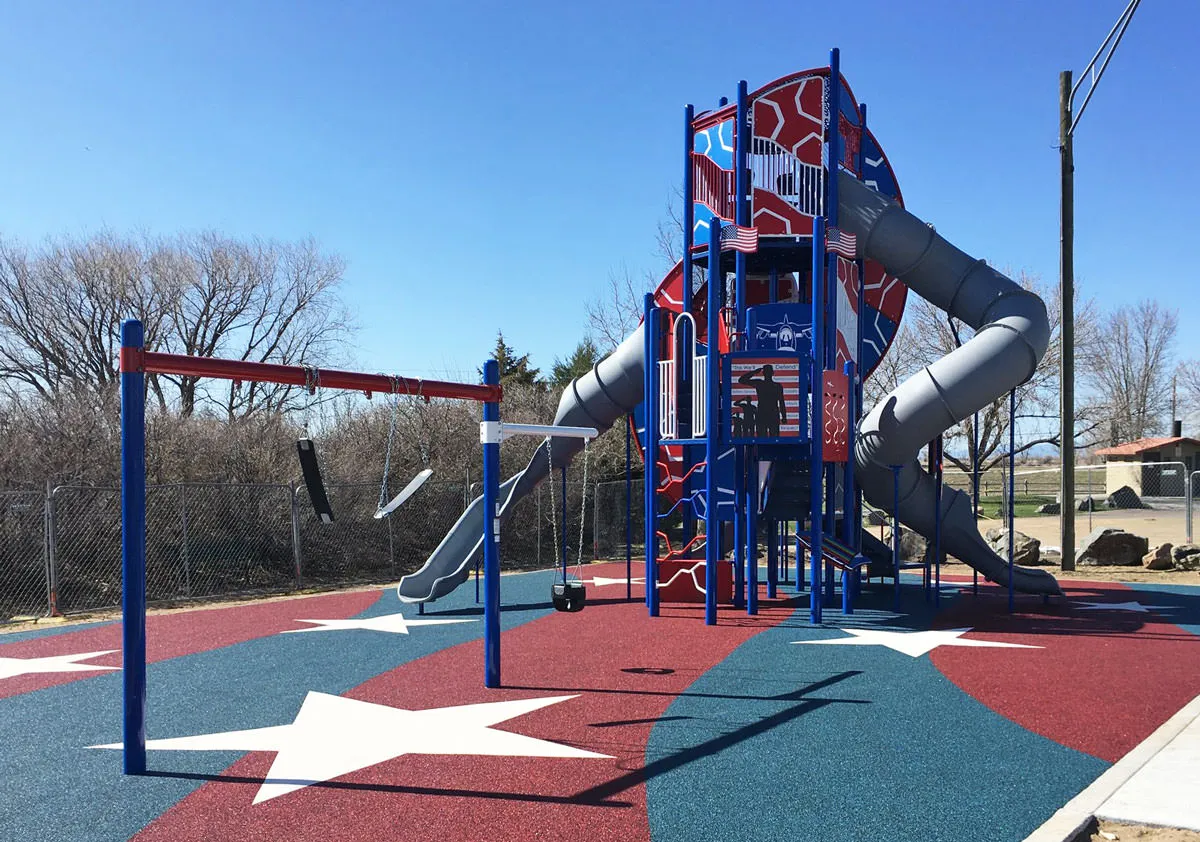 USA flag inspired playground with rubber matting and three story slide at Veteran's Park
